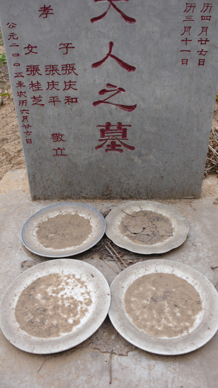tombstone with offerings